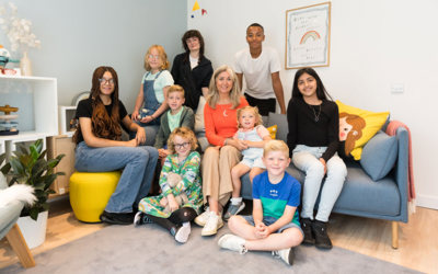 Children First CEO Mary Glasgow and children sit in the recovery room of the first Bairns Hoose